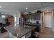 Open kitchen boasts granite countertops, stainless steel appliances, and sleek, dark cabinetry at 9160 Lynea Ct, Las Vegas, NV 89178