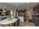 Spacious kitchen with granite countertops, dark wood cabinets, and an open layout connecting to the living area at 9160 Lynea Ct, Las Vegas, NV 89178