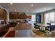 Modern kitchen featuring granite countertops, dark wood cabinets, stainless steel appliances, and a stylish breakfast nook at 9160 Lynea Ct, Las Vegas, NV 89178