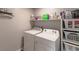 Functional laundry room with washer, dryer, shelving, and storage baskets for organization at 9160 Lynea Ct, Las Vegas, NV 89178