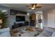 Comfortable living room with a ceiling fan, stylish decor, mounted TV, and plush seating for relaxation and entertainment at 9160 Lynea Ct, Las Vegas, NV 89178