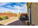 Cozy backyard patio with brick pavers, lush green bushes, and an outdoor dining set at 9160 Lynea Ct, Las Vegas, NV 89178