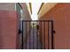 Gated walkway between two buildings, featuring a brick path and dark metal gate at 9160 Lynea Ct, Las Vegas, NV 89178