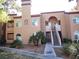 Inviting two-story condo building with desert landscaping, private balconies, and staircase entry at 9325 W Desert Inn Rd # 110, Las Vegas, NV 89117