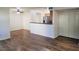 The living room opens to the kitchen and features hardwood floors and neutral paint at 9325 W Desert Inn Rd # 110, Las Vegas, NV 89117