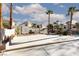 Backyard featuring a block wall, concrete patio, grass, tall palm trees, and neighboring houses at 9520 Wooden Pier Way, Las Vegas, NV 89117