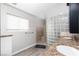 The bathroom features double sinks, a glass block shower, and a window at 9520 Wooden Pier Way, Las Vegas, NV 89117
