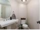 Powder room with a pedestal sink, modern fixtures, and neutral decor at 9520 Wooden Pier Way, Las Vegas, NV 89117