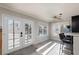 This dining area has natural light, a ceiling fan, and doors leading to the backyard and pool at 9520 Wooden Pier Way, Las Vegas, NV 89117