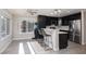 The kitchen features black cabinets, stainless steel appliances, a ceiling fan, and a breakfast bar at 9520 Wooden Pier Way, Las Vegas, NV 89117