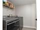 The laundry room features a modern washer and dryer with a wire rack shelf above for storage at 9520 Wooden Pier Way, Las Vegas, NV 89117