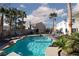 The backyard features a pristine pool, mature landscaping, and multiple seating areas at 9520 Wooden Pier Way, Las Vegas, NV 89117