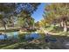 Scenic water feature surrounded by mature trees and landscaping in a natural setting at 9520 Wooden Pier Way, Las Vegas, NV 89117