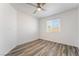 Bedroom featuring a ceiling fan, neutral paint, gray wood floors and a window with blinds at 9748 Derbyhill Cir, Las Vegas, NV 89117