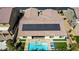 Aerial view of home with solar panels, pool, spa, and lawn at 9779 Mosaic Canyon Ct, Las Vegas, NV 89149