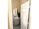 Nicely appointed half-bathroom with gray vanity, round mirror, and neutral paint at 9792 Cordova Vista Ct, Las Vegas, NV 89183
