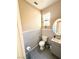 Well-lit powder room with penny tile backsplash, gray floors, and gray vanity at 9792 Cordova Vista Ct, Las Vegas, NV 89183