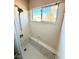 Bathroom shower with a marble tiled wall and patterned window at 9792 Cordova Vista Ct, Las Vegas, NV 89183