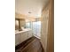 Well-lit bathroom featuring double sinks, wood flooring, and a glass door shower at 9792 Cordova Vista Ct, Las Vegas, NV 89183