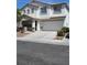 Charming two-story home with a two car garage, a well-manicured front yard and long driveway at 9792 Cordova Vista Ct, Las Vegas, NV 89183