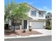 Charming two-story home with a two car garage, a well-manicured front yard, and mature landscaping at 9792 Cordova Vista Ct, Las Vegas, NV 89183