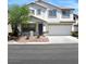 Charming two-story home with a two car garage, a well-manicured front yard, and a large tree at 9792 Cordova Vista Ct, Las Vegas, NV 89183