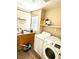 Functional laundry room with washer, dryer, and ample storage space at 9792 Cordova Vista Ct, Las Vegas, NV 89183