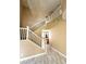 Grand foyer featuring a staircase, chandelier, and tiled floors leading to an open concept kitchen at 9792 Cordova Vista Ct, Las Vegas, NV 89183