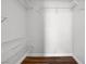 Walk-in closet with adjustable wire shelving and wood flooring at 9901 Trailwood Dr # 2144, Las Vegas, NV 89134
