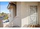 Close-up of a unit entrance with security screen door, exterior lighting, and unit numbers at 9901 Trailwood Dr # 2144, Las Vegas, NV 89134