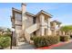 Inviting condo exterior featuring well-maintained landscaping and staircase leading to upper units at 9901 Trailwood Dr # 2144, Las Vegas, NV 89134