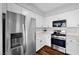 Updated kitchen with stainless steel refrigerator and gas range, complemented by bright white cabinets at 9901 Trailwood Dr # 2144, Las Vegas, NV 89134