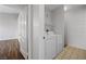 This is a laundry area with white washer and dryer, and overhead wire shelving for convenience at 9901 Trailwood Dr # 2144, Las Vegas, NV 89134