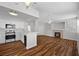 Bright open-concept living room with wood flooring, fireplace, and direct kitchen access at 9901 Trailwood Dr # 2144, Las Vegas, NV 89134
