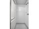 A walk-in shower with white tiled walls and a shower head. Features a built-in soap dish for convenience at 9901 Trailwood Dr # 2144, Las Vegas, NV 89134