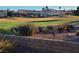 Backyard landscaping with a retaining wall and scenic view of the golf course and neighborhood at 9937 Villa Ridge Dr, Las Vegas, NV 89134
