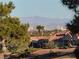 Distant view of mountains from rooftop with a house in the foreground at 9937 Villa Ridge Dr, Las Vegas, NV 89134