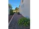 Landscaped side yard with gravel, bushes and plants adjacent to golf course at 9937 Villa Ridge Dr, Las Vegas, NV 89134