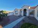 Charming single-story home with desert landscaping, a red tile roof, and an arched entrance at 9937 Villa Ridge Dr, Las Vegas, NV 89134