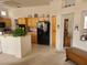 Bright kitchen with stainless appliances, tile floors, and breakfast bar seating at 9937 Villa Ridge Dr, Las Vegas, NV 89134
