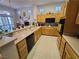 Open kitchen with white countertops, light wood cabinetry, and a seamless transition to the dining area at 9937 Villa Ridge Dr, Las Vegas, NV 89134