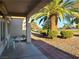 Covered patio with seating area and view of a palm tree and the golf course at 9937 Villa Ridge Dr, Las Vegas, NV 89134