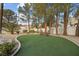 Relaxing backyard with manicured turf, mature trees, and serene privacy at 10 Innisbrook Ave, Las Vegas, NV 89113