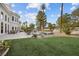 Lush backyard with artificial turf, mature trees, and elegant landscaping for relaxing and entertaining at 10 Innisbrook Ave, Las Vegas, NV 89113