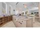 Open wet bar area with marble countertops, decorative lighting and a bar fridge perfect for entertaining at 10 Innisbrook Ave, Las Vegas, NV 89113