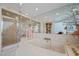 Elegant bathroom features a soaking tub, glass shower, marble surfaces and neutral color palette at 10 Innisbrook Ave, Las Vegas, NV 89113