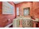 Unique powder room with a wall mounted decorative art and a stone vessel sink and vanity at 10 Innisbrook Ave, Las Vegas, NV 89113
