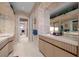 Bright bathroom boasts a lengthy vanity, ample storage, and seamless access to adjoining rooms, highlighting convenience at 10 Innisbrook Ave, Las Vegas, NV 89113