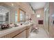 Elegant bathroom features a large mirror, marble countertop, and a decorative stool, exuding luxury and comfort at 10 Innisbrook Ave, Las Vegas, NV 89113