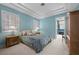 Cozy bedroom featuring a tray ceiling, bedside tables, and plantation shutters at 10 Innisbrook Ave, Las Vegas, NV 89113